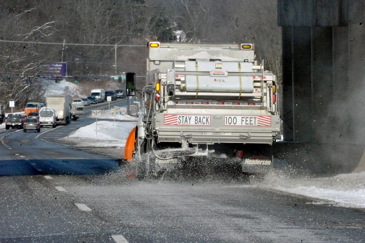 A Wooster plow clears snow along the berm and spreads salt on Cleveland Road.