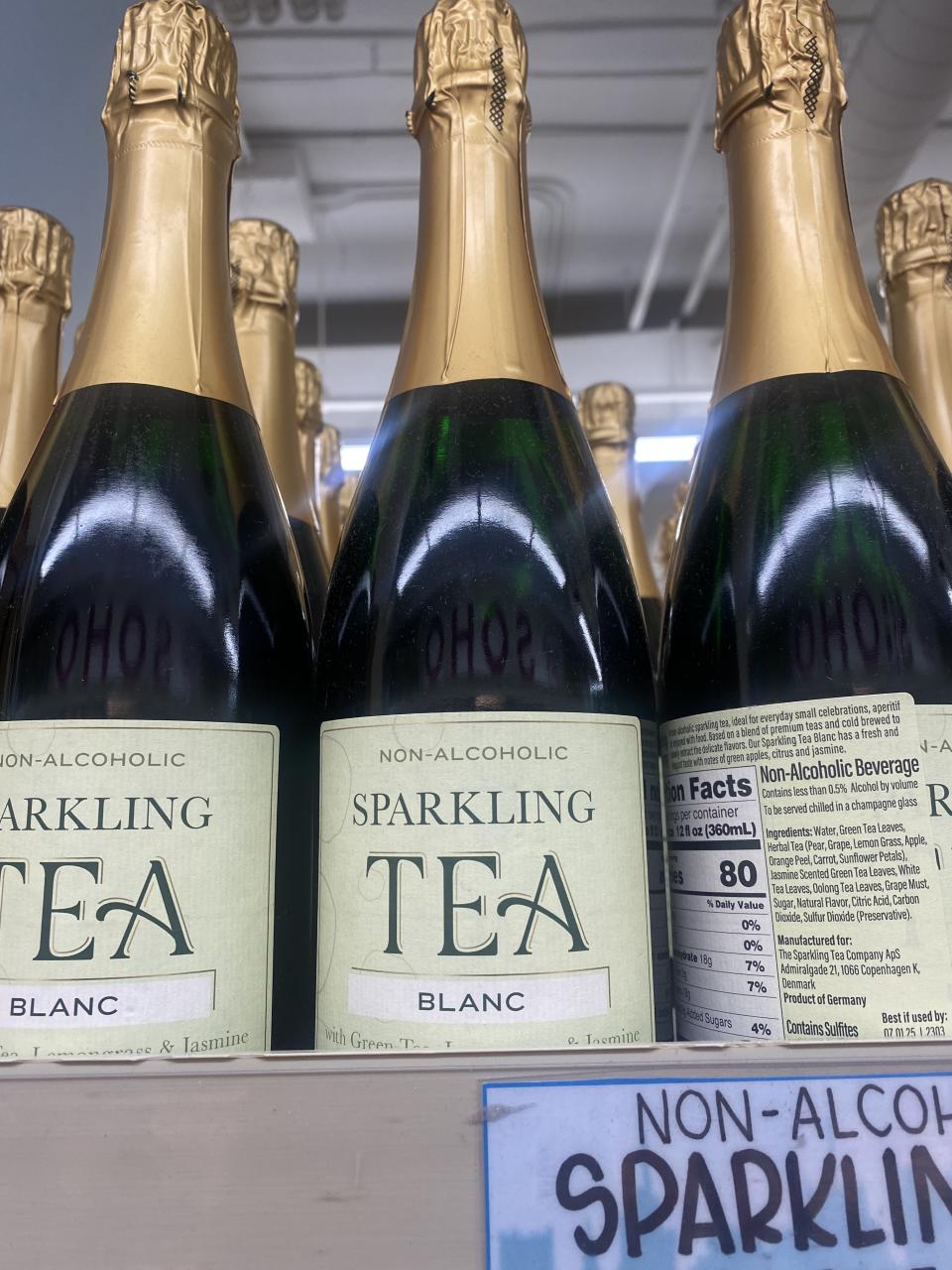 bottles of non-alcoholic blanc sparkling tea on a shelf