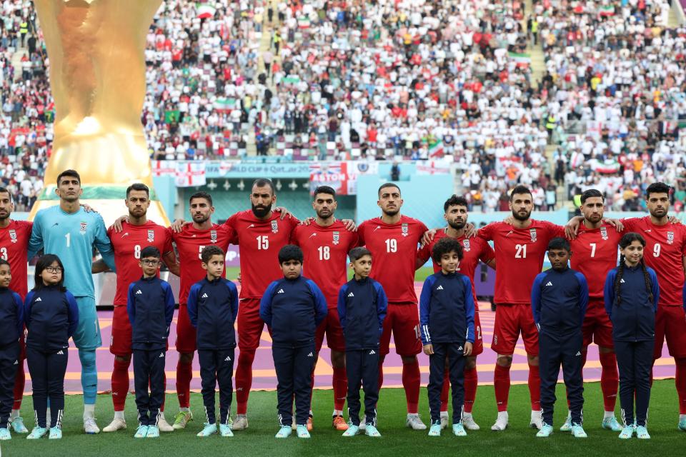 Iran players listen to the national anthem ahead of the Qatar 2022 World Cup Group B football match between England and Iran at the Khalifa International Stadium in Doha on November 21, 2022. (Photo by FADEL SENNA / AFP) (Photo by FADEL SENNA/AFP via Getty Images)