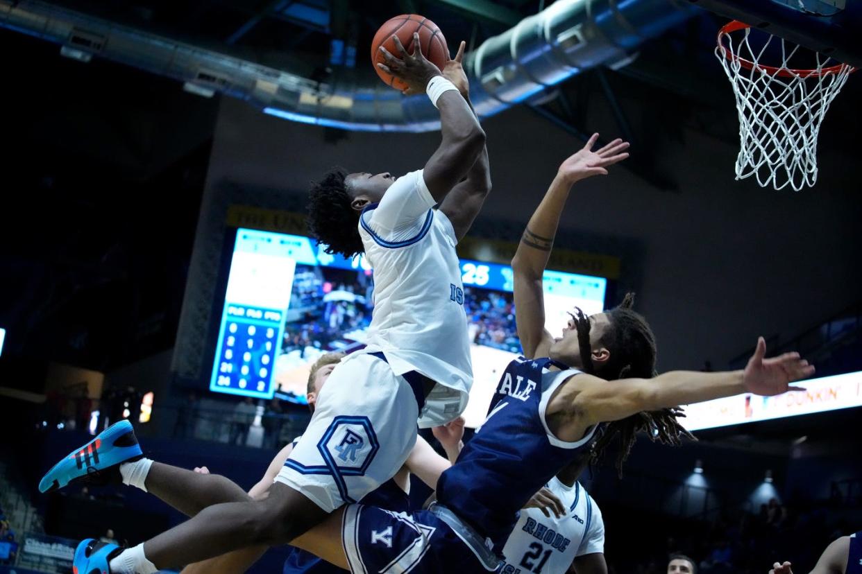 Jaden House collides with Yale forward Casey Simmons on his way to the hoop in the first half.