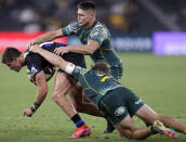 Argentina's Bautista Delguy, left, is tackled by Australia's Michael Hooper, right, and James O'Connor during their Tri-Nations rugby union match in Sydney, Australia, Saturday, Dec. 5, 2020. (AP Photo/Rick Rycroft)