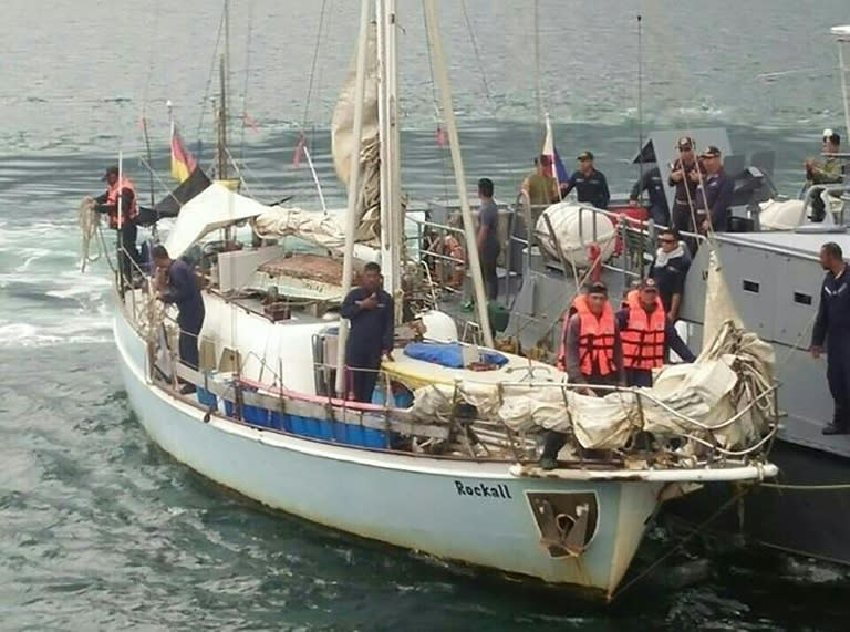 Philippine navy personnel stand onboard the yatch Rockall, where the body of a naked white woman who had been shot was found aboard, after it was in Sulu province