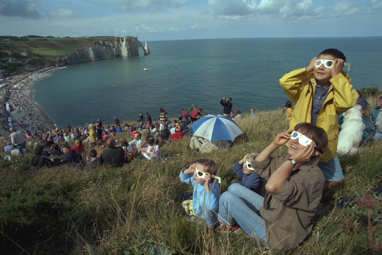 1999: Hundreds of people view an eclipse from a hillside in Étretat, France. 