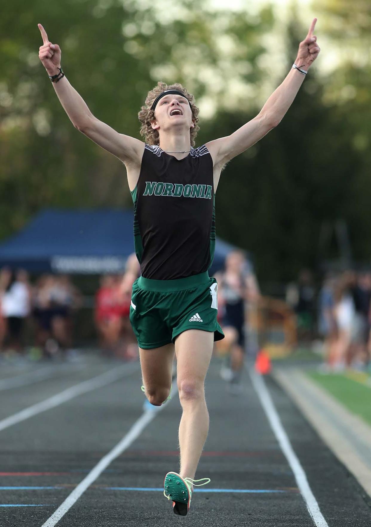 Chris Turner of Nordonia reacts to running to a first place finish in the 3200 meter run with a time of 9:33.70 during the Suburban League National Conference track meet in Twinsburg on Thursday. 