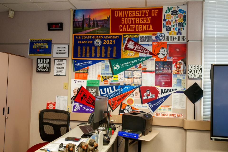 Cindy Bellamy, an English teacher at Palm Springs High School, displays college banners inside her classroom in Palm Springs, Calif., on Tuesday, August 9, 2022.  