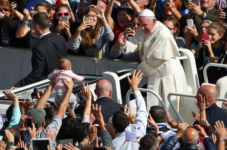 Pope Francis waves as he leaves at the end of a Marian vigil mass in Saint Peter's square at the Vatican, October 9, 2016. REUTERS/Alessandro Bianchi