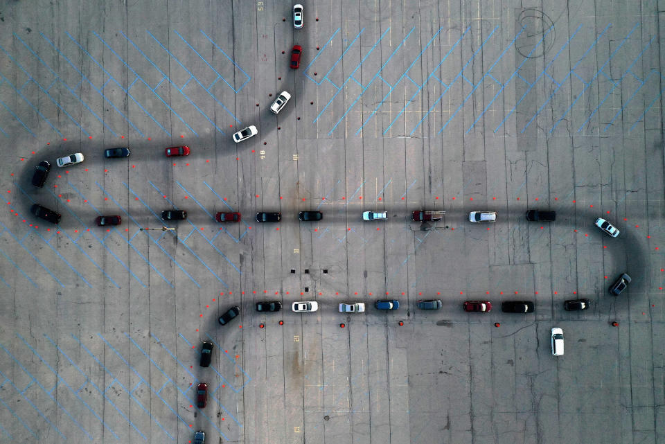 Image: An aerial view of vehicles waiting at a drive-thru Covid-19 testing site in the parking lot of Miller Park in Milwaukee, Wisconsin. (Bing Guan / Reuters file)