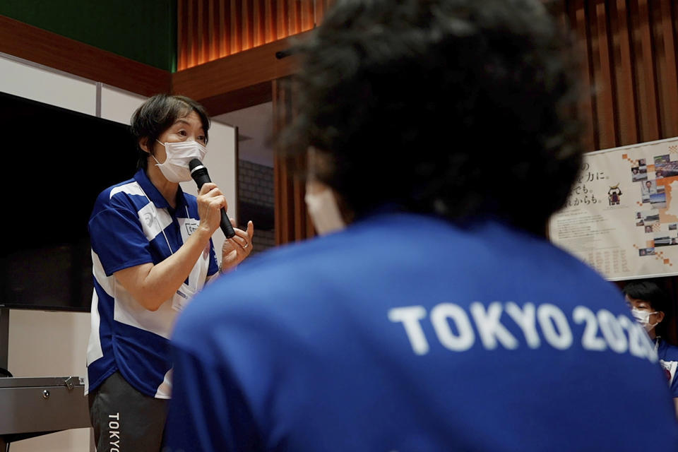 Olympic volunteer Mieko Onuma talks about her experiences of the 2011 earthquake, also known as the Great East Japan Earthquake, at Tohoku Fukushi University in Sendai, Japan, Wednesday, July 28, 2021. The Tokyo Olympics was billed as the “Recovery and Reconstruction Games,” with the torch relay starting in disaster-hit Fukushima and several events held in Fukushima and Miyagi. However, the coronavirus pandemic has disrupted opportunities to showcase the region’s restoration to foreign spectators. (AP Photo/Chisato Tanaka)