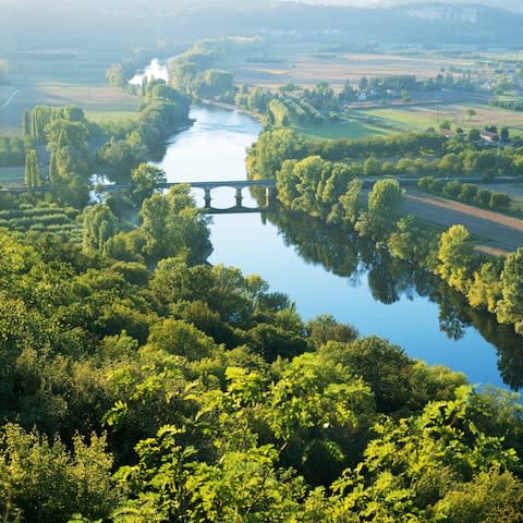 A view of river and fields in Dordogne - Credit: Gary Yeowell/Getty