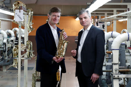 Jerome Selmer, CEO of Henri Selmer Paris, and Louis Godron, CEO and Partner at Argos Soditic, pose at the Henri Selmer wind instruments factory in Mantes-la-Ville near Paris, France, January 17, 2018. REUTERS/Benoit Tessier