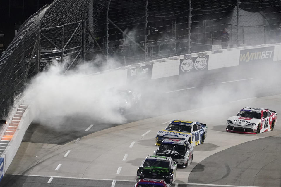Brennan Poole stops in Turn 4 behind a cloud of smoke after an engine failure at the start of the NASCAR Xfinity Series auto race at Martinsville Speedway on Friday, April 8, 2022, in Martinsville, Va. (AP Photo/Steve Helber)