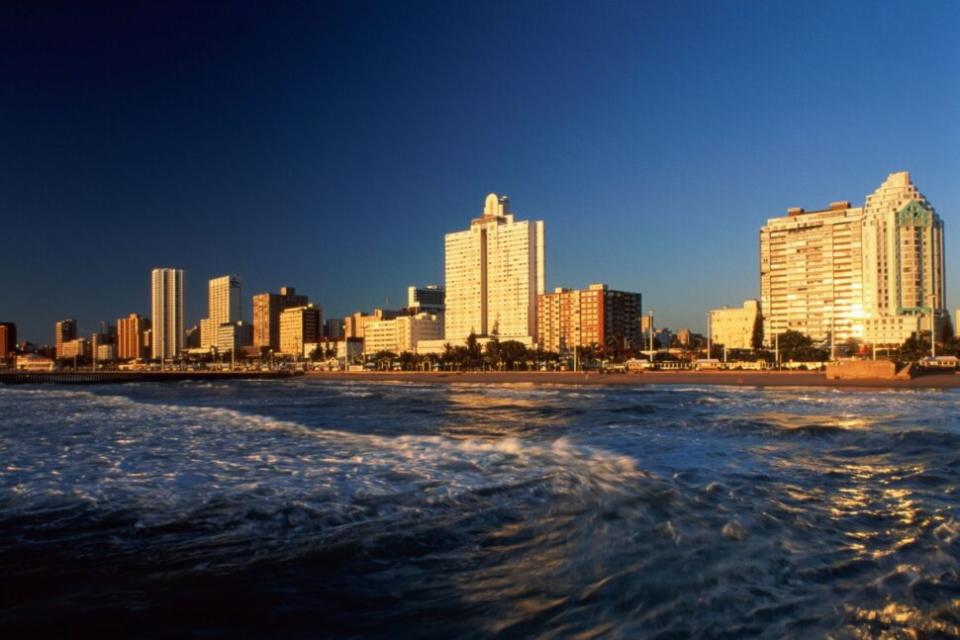 beach shoreline in Durban, South Africa with hotels in the distance