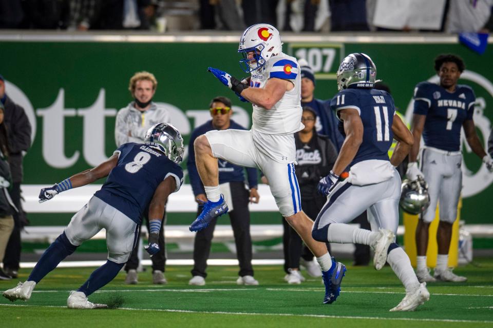 Colorado State's Trey McBride carries the football against Nevada on Saturday, Nov. 27, 2021, at Canvas Stadium in Fort Collins.