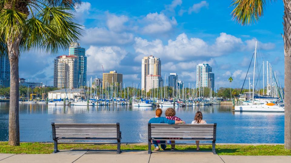 Young adults on a park bench over the bay at St.