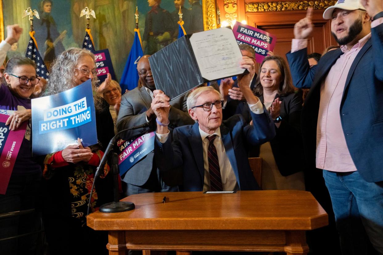 <span>Tony Evers shows new signed legislative maps on Monday at the state capitol.</span><span>Photograph: Mark Hoffman/AP</span>