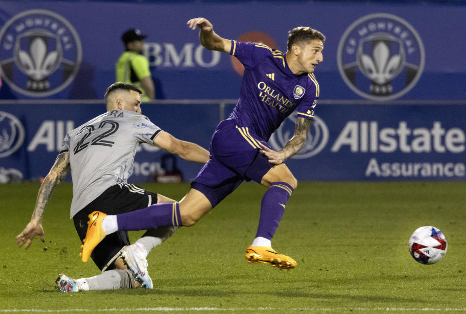 CF Montreal defender Aaron Herrera, left, and Orlando City forward Gaston Gonzalez collide during the second half of an MLS soccer game in Montreal, Saturday, May 6, 2023. (Allen McInnis/The Canadian Press via AP)