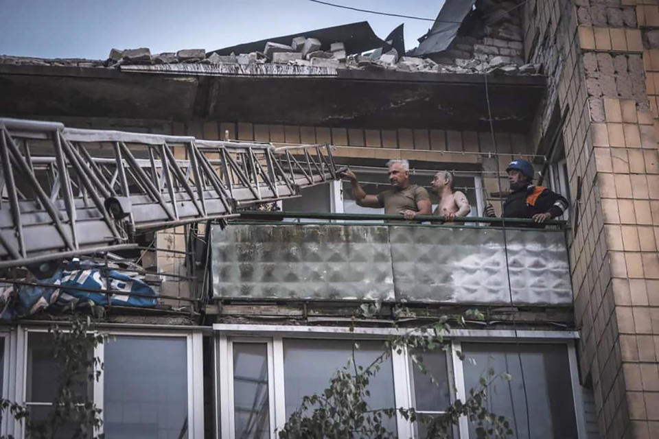 In this photo provided by the Ukrainian Emergency Service, rescuers evacuate people from a damaged building after Russian missile strikes in Pokrovsk, Donetsk region, Ukraine, Monday, Aug. 7, 2023. (Ukrainian Emergency Service via AP)