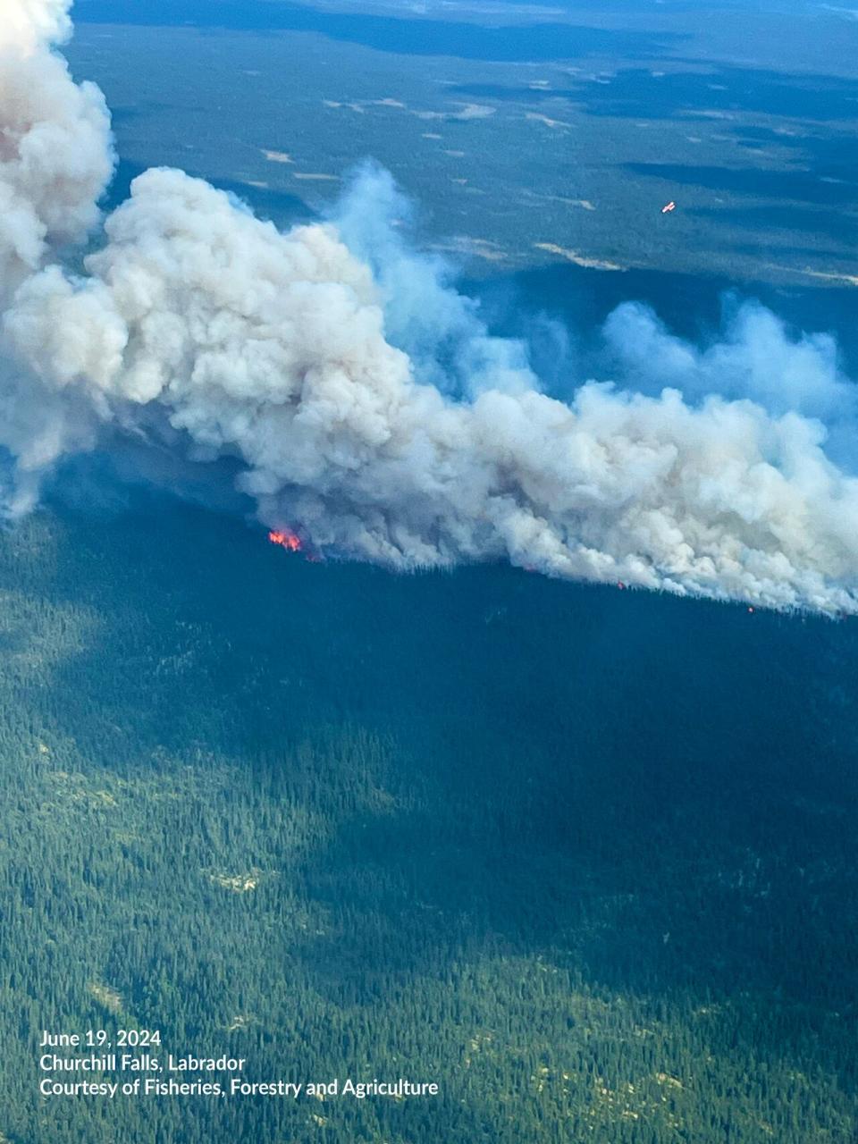 This photo, provided by the Department of Fisheries, Forestry and Agriculture, shows the Churchill Falls fire on Wednesday, June 19. The fire has since shrunk in size.