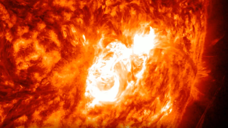  Solar flare erupting from the surface of the sun in a bright flash of light. 