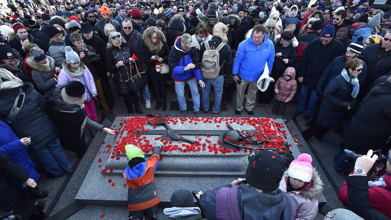 People of all ages are seen at the Tomb of the Unknown Soldier in Ottawa on Nov. 11, 2017, for the National Remembrance Day Ceremony. Would more people attend ceremonies like this one if Remembrance Day was a statutory holiday across Canada? Photo from The Canadian Press.