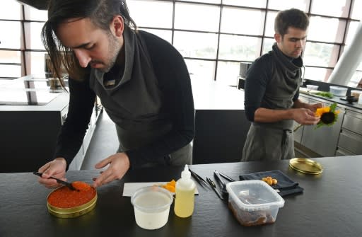 Chef Jordan Kahn (L) prepares a dish at his restaurant Vespertine