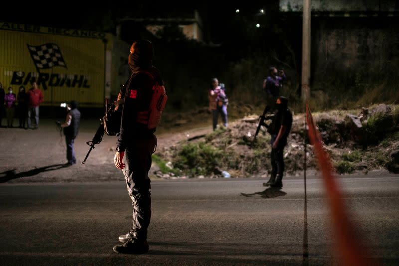 Police keep watch at a scene where 19 people were killed, in Zinapecuaro