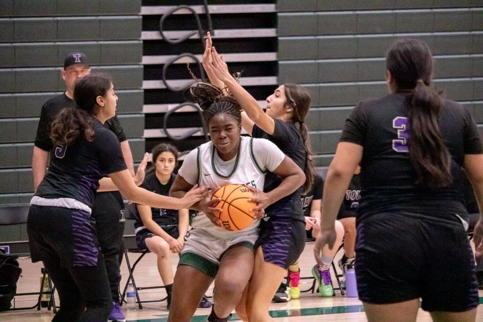 Manteca's Jada Ikharo (center) begins to pass the ball as the Tokay Tigers begin to attack at Manteca High school in Manteca, CA on Dec. 5, 2023.