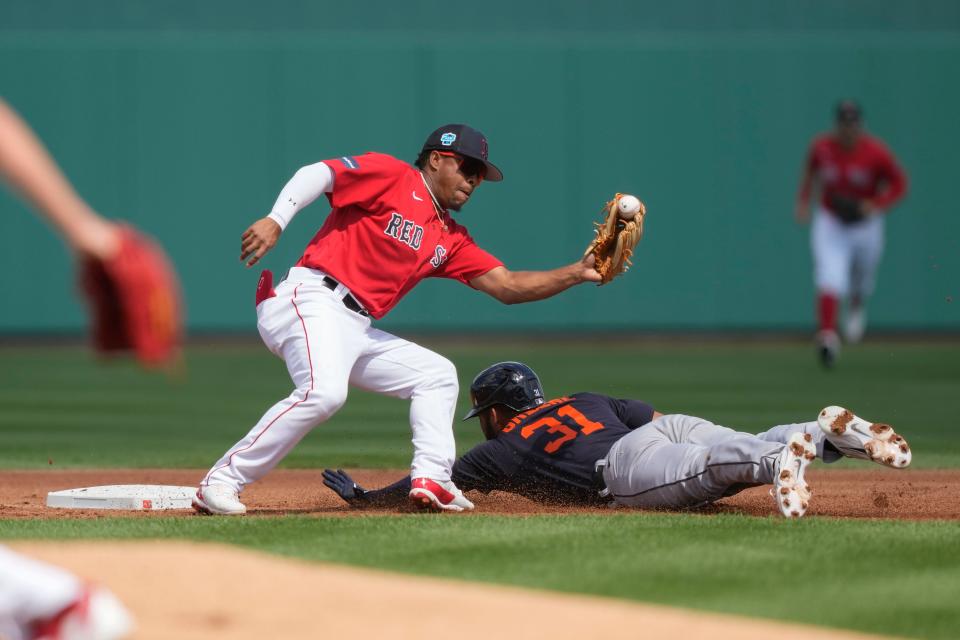 Detroit Tigers center fielder Riley Greene steals second base as Boston Red Sox third baseman Enmanuel Valdez covers in the first inning of their spring training baseball game in Fort Myers, Fla., Monday, March 6, 2023.