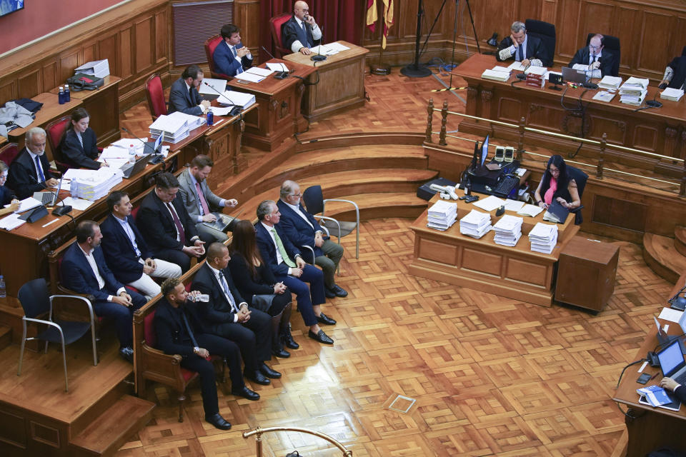 Former FC Barcelona player Neymar who now plays for Paris Saint-Germain, lower centre left, drinks water while sitting in court in Barcelona, Spain, Monday Oct. 17, 2022. Neymar is in court to face a trial over alleged irregularities involving his transfer to Barcelona in 2013. Neymar's parents, former Barcelona president Sandro Rosell and representatives for both the Spanish club and Brazilian team Santos are also in court after a complaint brought by Brazilian investment group DIS regarding the amount of the player's transfer. All defendants have denied wrongdoing. (AP Photo/Joan Mateu Parra)