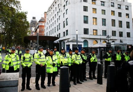 Police watch protestors at a 'Disabled Rebels' demonstration organised by Extinction Rebellion outside New Scotland Yard in London