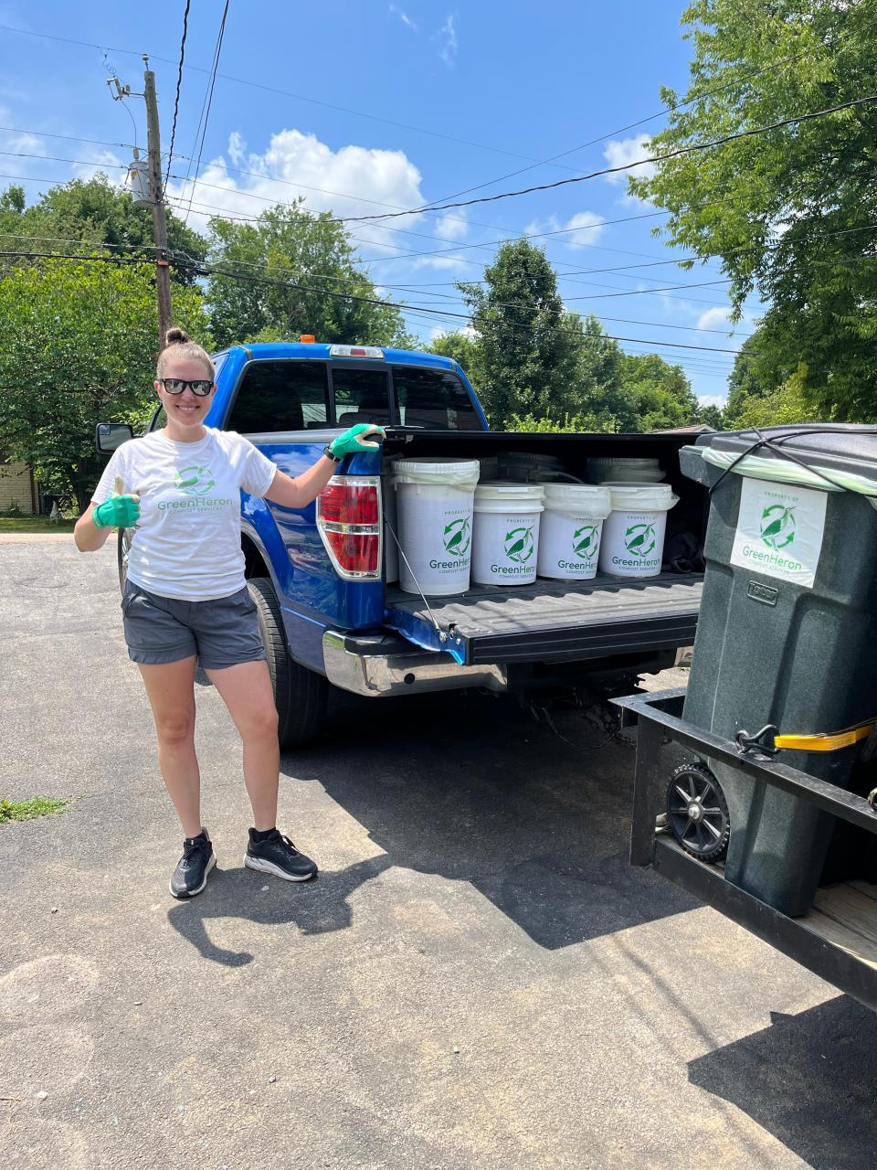 Kat McDearis, co-founder of Green Heron Composting Service, on her daily collection route with “Blue Steel,” the company’s truck. 2022