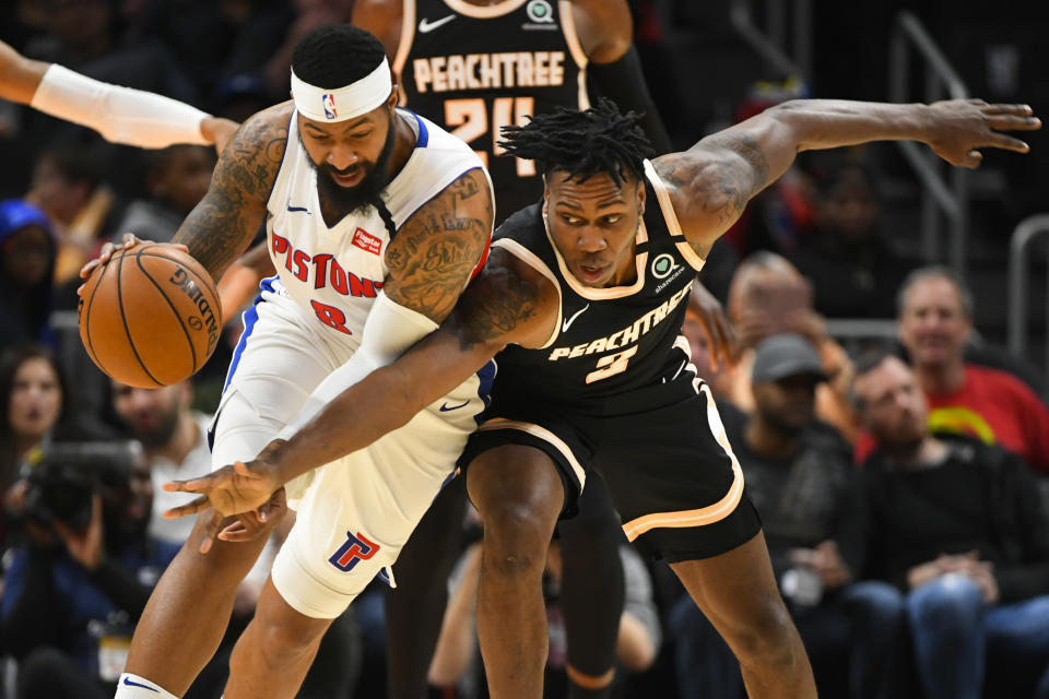 Atlanta Hawks guard Treveon Graham, right, reaches in against Detroit Pistons forward Markieff Morris, left, during the second half of an NBA basketball game Saturday, Jan. 18, 2020, in Atlanta. (AP Photo/John Amis)