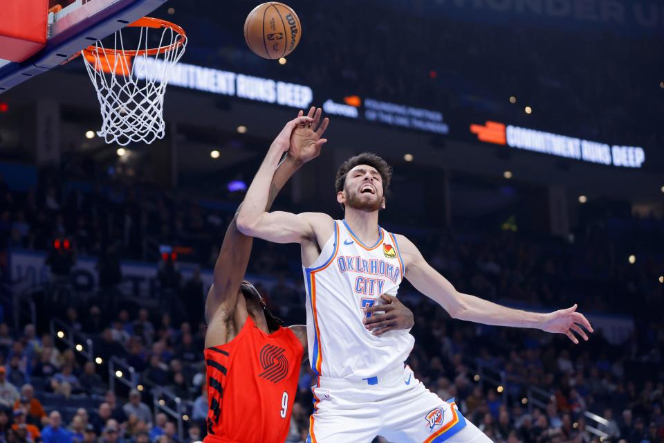 Oklahoma City Thunder forward Chet Holmgren (7) makes a basket as he is fouled by Portland Trail Blazers forward Jerami Grant (9) during an NBA basketball game between the Oklahoma City Thunder and the Portland Trail Blazers at Paycom Center in Oklahoma City, Thursday, Jan. 11, 2024.