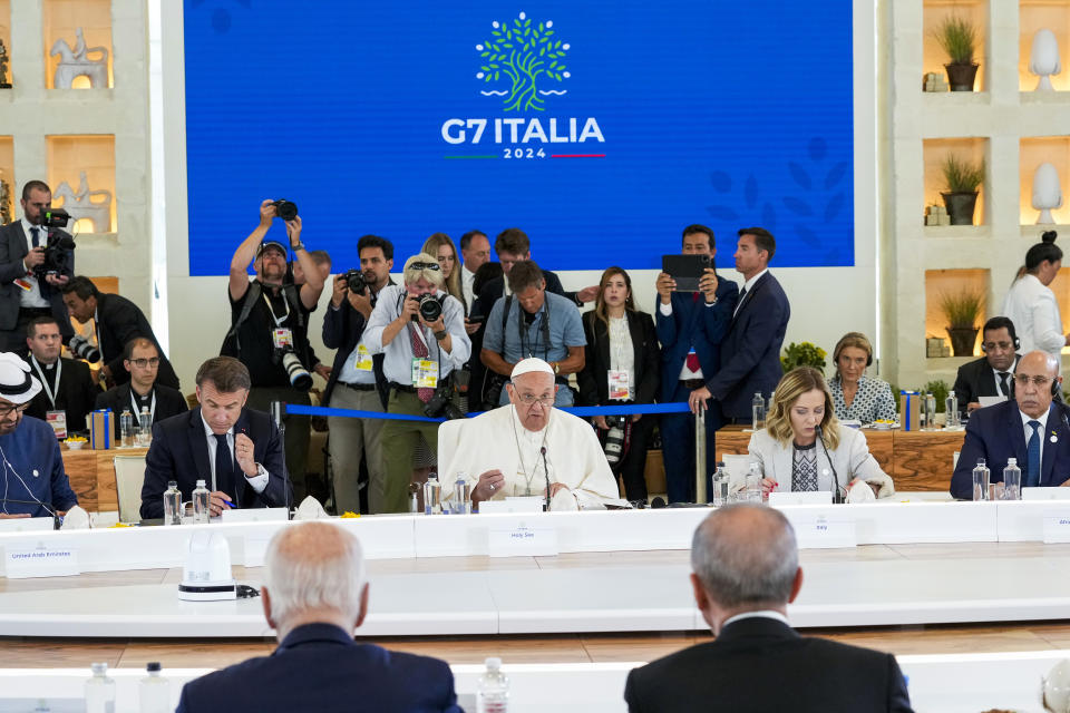 Pope Francis, center, addresses world leaders during a working session on AI, Energy, Africa and Mideast at the G7 summit, in Borgo Egnazia, near Bari in southern Italy, Friday, June 14, 2024. (AP Photo/Andrew Medichini)