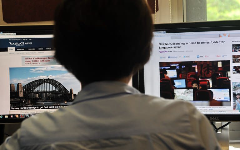 A person is seen browsing media websites in Singapore, on May 30, 2013. Singapore's official media watchdog refuted claims by online critics that a new rule requiring news websites to obtain licences was aimed at stifling Internet freedom