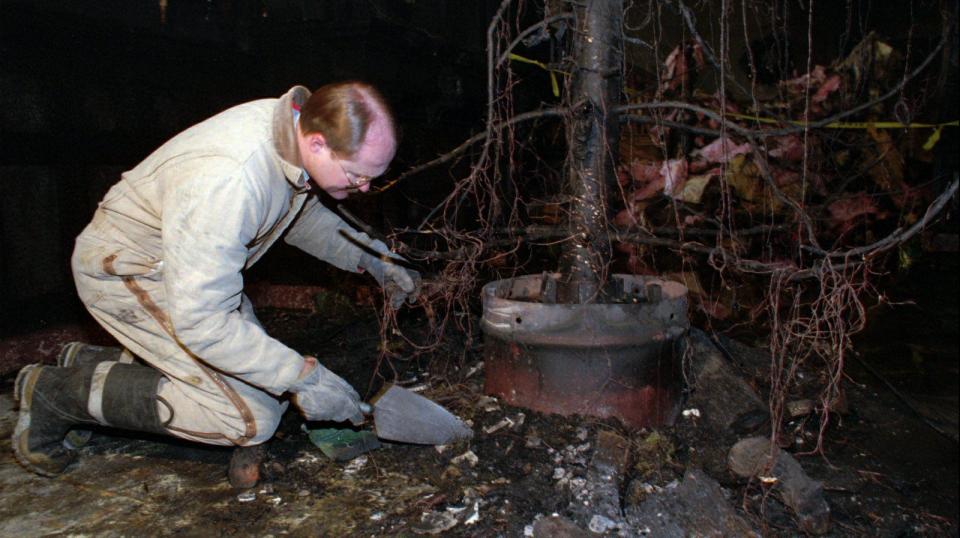 A fire inspector examines the base of a Christmas tree for clues to the fire’s origins inside the Governor’s Mansion after a Christmas tree fire Dec. 15, 1993, in Salt Lake City, Utah. | Jeffrey D. Allred, Deseret News