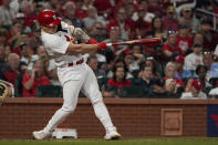 St. Louis Cardinals' Tyler O'Neill follows through on an RBI single during the fifth inning of a baseball game against the Milwaukee Brewers Tuesday, Sept. 28, 2021, in St. Louis. O'Neill made it to third on a fielding error by Brewers right fielder Avisail Garcia on the play. (AP Photo/Jeff Roberson)