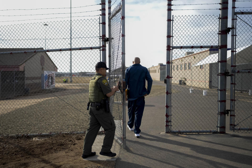 Officer Jimmy Bliatout closes a gate after letting a prisoner enter the yard at Valley State Prison in Chowchilla, Calif., Friday, Nov. 4, 2022. (AP Photo/Jae C. Hong)