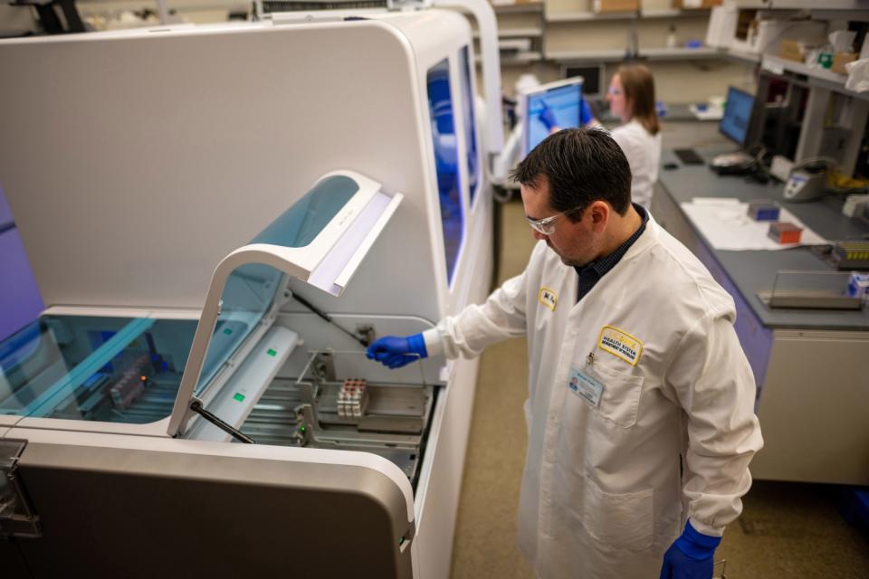 A machine to test for the coronavirus is demonstrated at UC Davis.