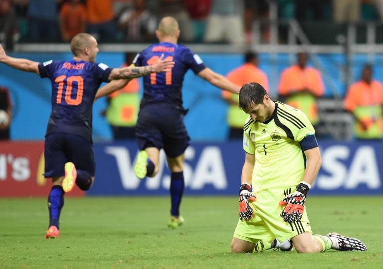 Spain's goalkeeper Iker Casillas bows his head after the Netherlands' Arjen Robben (centre) scored his team's fifth goal during the World Cup match at the Fonte Nova Arena in Salvador, on June 13, 2014