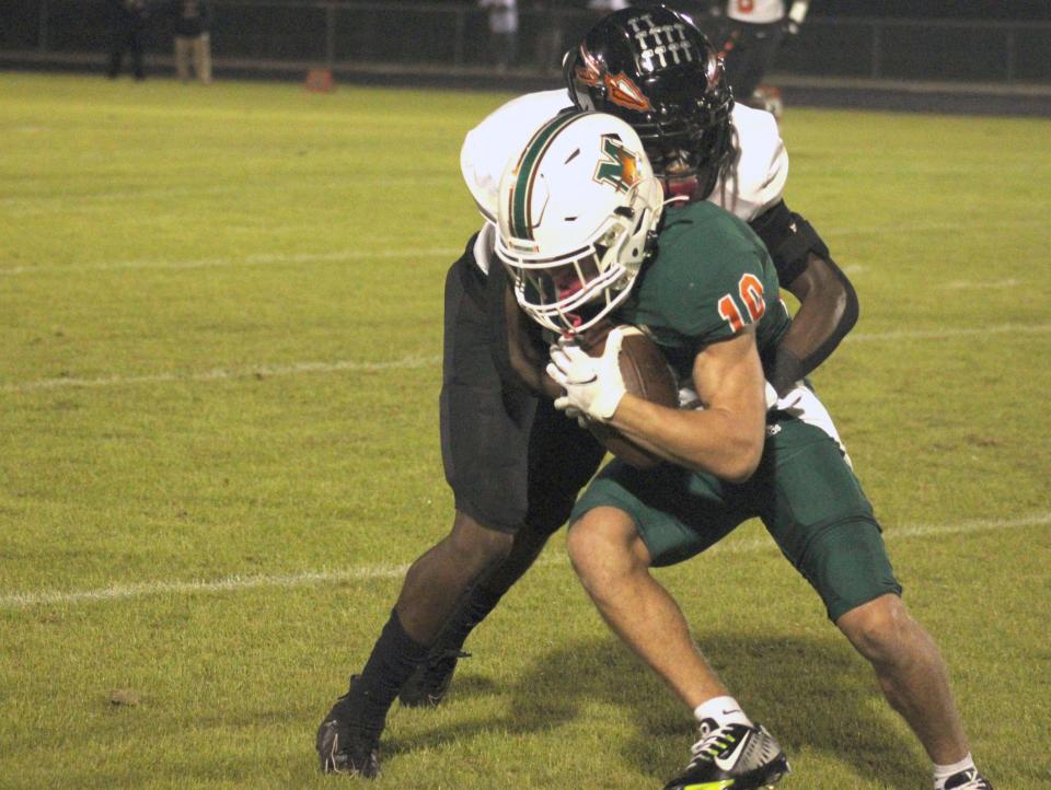 Mandarin receiver Willem Griego (10) presses for yardage against the Sanford Seminole defense in the teams' 2022 playoff meeting.