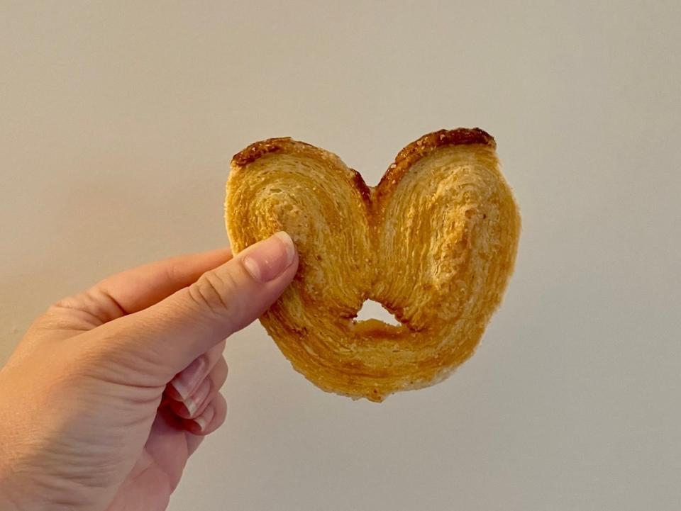 Writer holding a flaky cookie