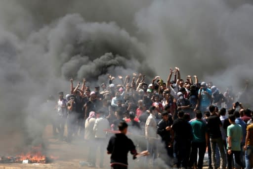 Palestinian demonstrators burn tyres near the Gaza-Israel border on May 14, 2018