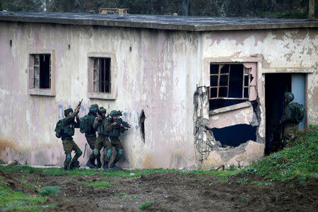 FILE PHOTO: Israeli soldiers take part in an exercise in the Israeli-occupied Golan Heights, near the ceasefire line between Israel and Syria, March 20, 2017. REUTERS/Baz Ratner/File Photo