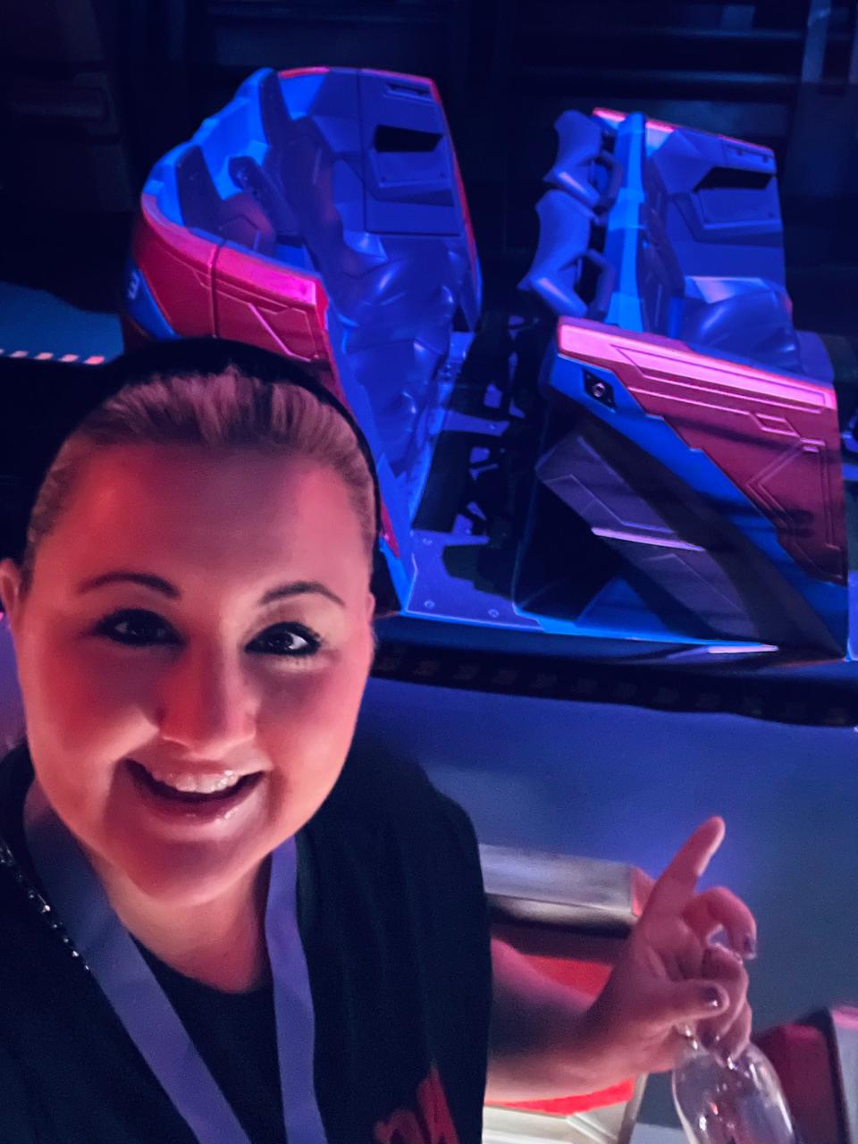 carly pointing at the ride vehicles for guardians of the galaxy cosmic rewind disney world