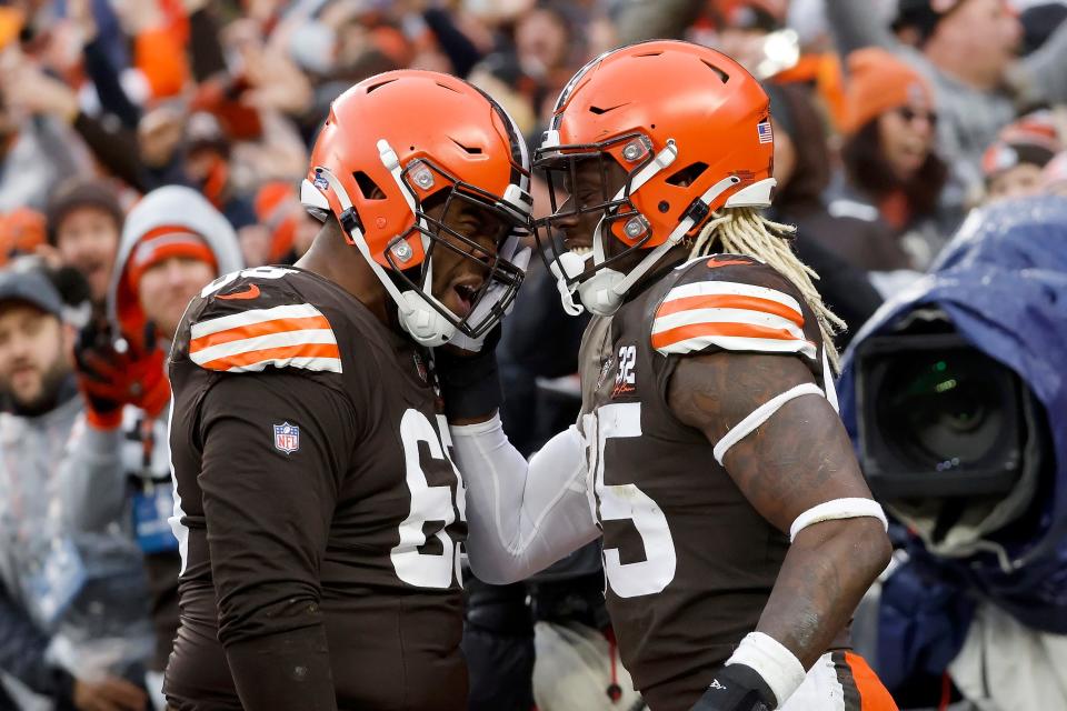 Cleveland Browns tight end David Njoku (85) is congratulated by offensive tackle Leroy Watson IV (69) after scoring a touchdown during an NFL football game against the Chicago Bears, Sunday, Dec. 17, 2023, in Cleveland. (AP Photo/Kirk Irwin)
