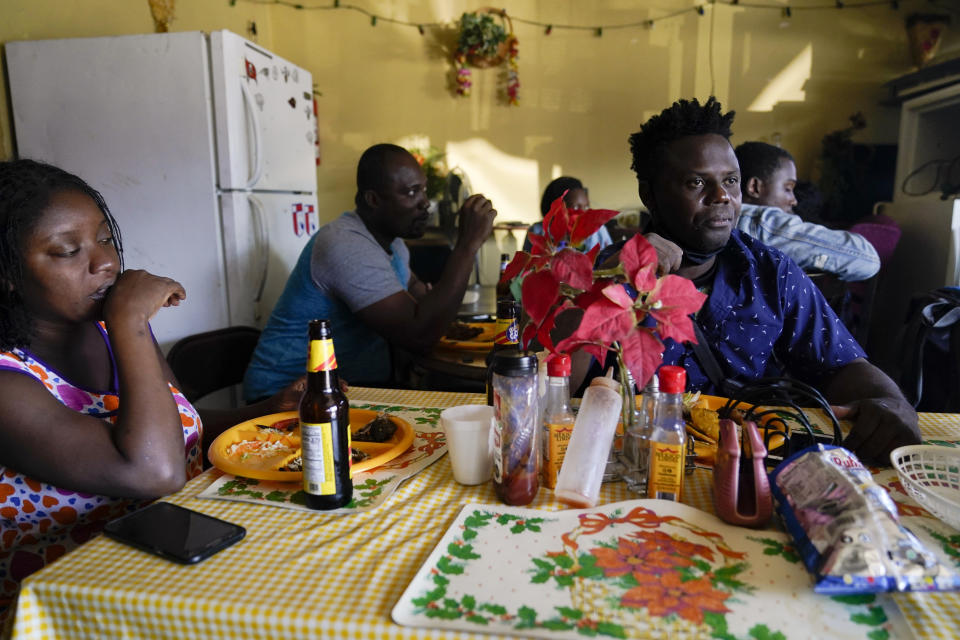 Robins Exile, of Haiti, eats at a Haitian restaurant, Monday, Sept. 20, 2021, in Tijuana, Mexico. Exile arrived to Tijuana a day earlier after changing his plans to head to the Texas border where thousands of Haitians have converged in recent days and now face deportation. He said messages on WhatsApp and Facebook from fellow Haitian migrants and their videos on YouTube warned him to steer clear of Ciudad Acuna, Mexico, across from Del Rio, Texas, and said it no longer is the easy place to cross into the U.S. that it was just a few weeks ago. (AP Photo/Gregory Bull)