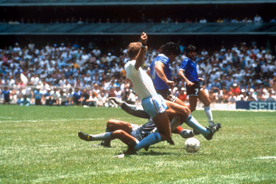 Diego Maradona slots home his famous World Cup goal, giving Peter Reid nightmares. (PA)