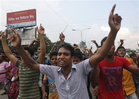 Garment workers shout slogans as they block a street during a protest in front of the head office of the Bangladesh Garment Manufactures & Exporters Association (BGMEA), in Dhaka September 23, 2013. REUTERS/Andrew Biraj
