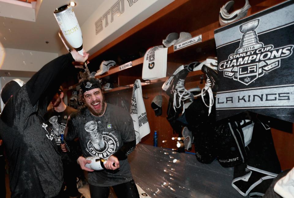 Los Angeles Kings center Anze Kopitar, of Slovenia, celebrates in the locker room after his team won the Stanley Cup in double overtime over the New York Rangers in Game 5 of the 2014 Stanley Cup Final series Friday, June 13, 2014, in Los Angeles, California. The Kings won the game 3-2. (AP Photo/ Dave Sandford, NHLI via Getty Images, pool)